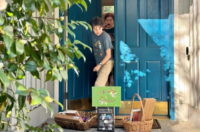 Woman and boy standing near a basket of sweets and other items