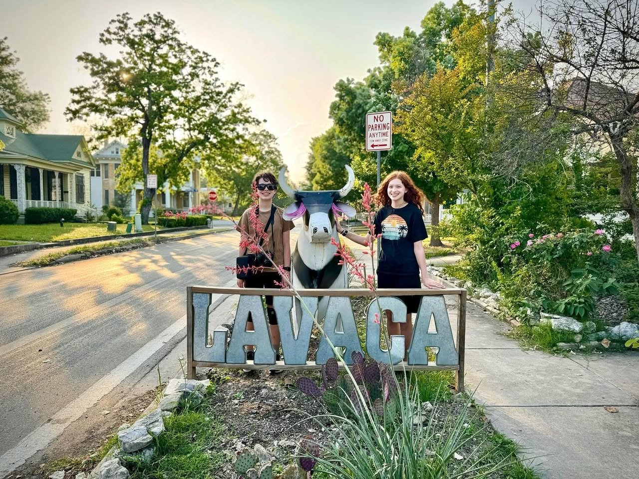 Lavaca, San Antonio Two travelers standing beside the historic Lavaaca landmark sign on a cozy street in Galveston, Texas.