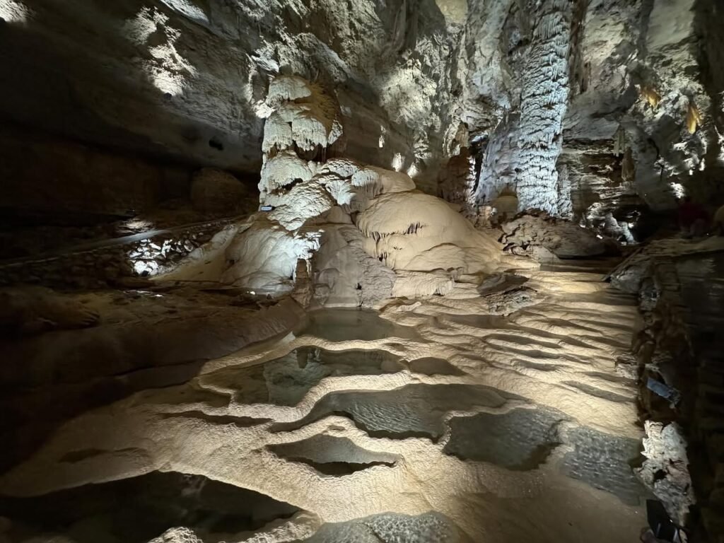 A series of photos showing the cave system created by flowing lava, featuring textured stone surfaces and illuminated wooden walkways.
