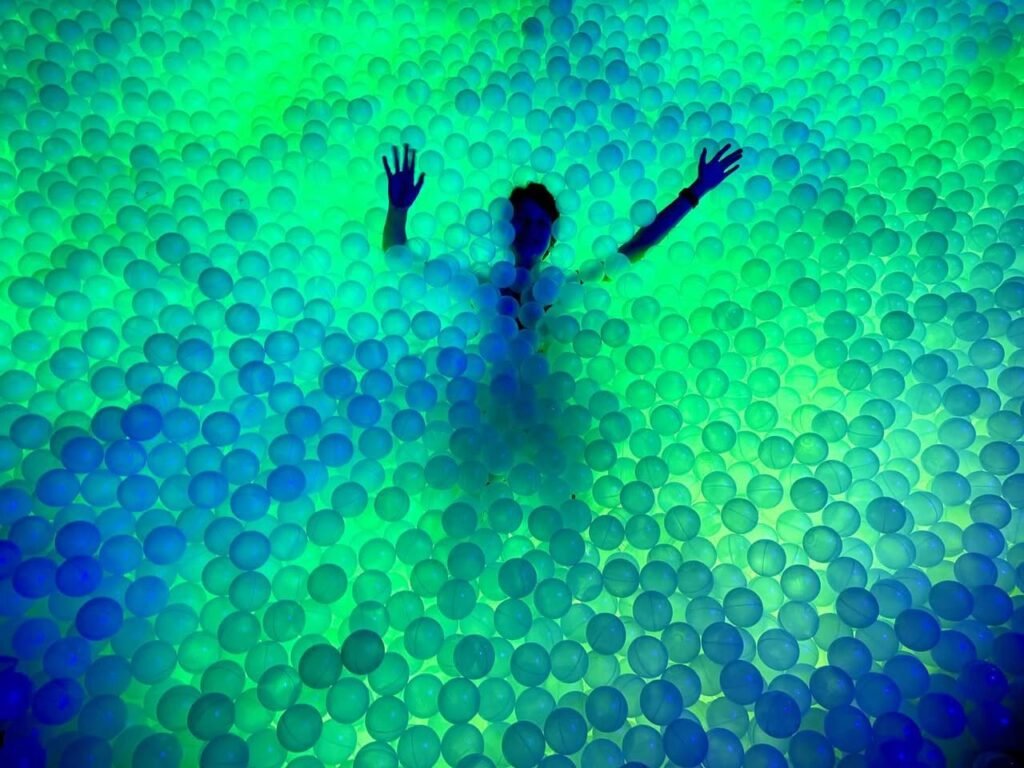 A colorful image featuring purple dots on a green background.