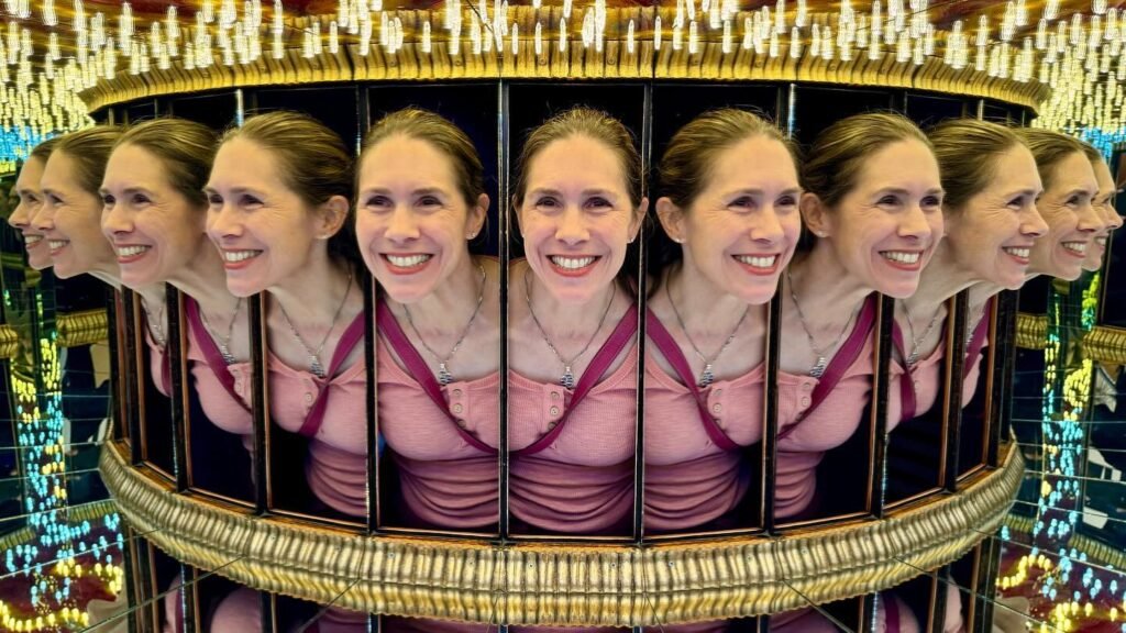 A reflection in a circular mirror array creates the illusion of multiple faces.