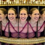 A reflection in a circular mirror array creates the illusion of multiple faces.