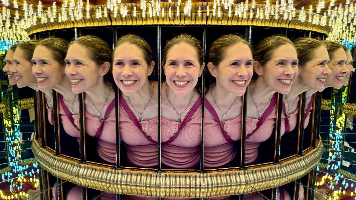 A reflection in a circular mirror array creates the illusion of multiple faces.