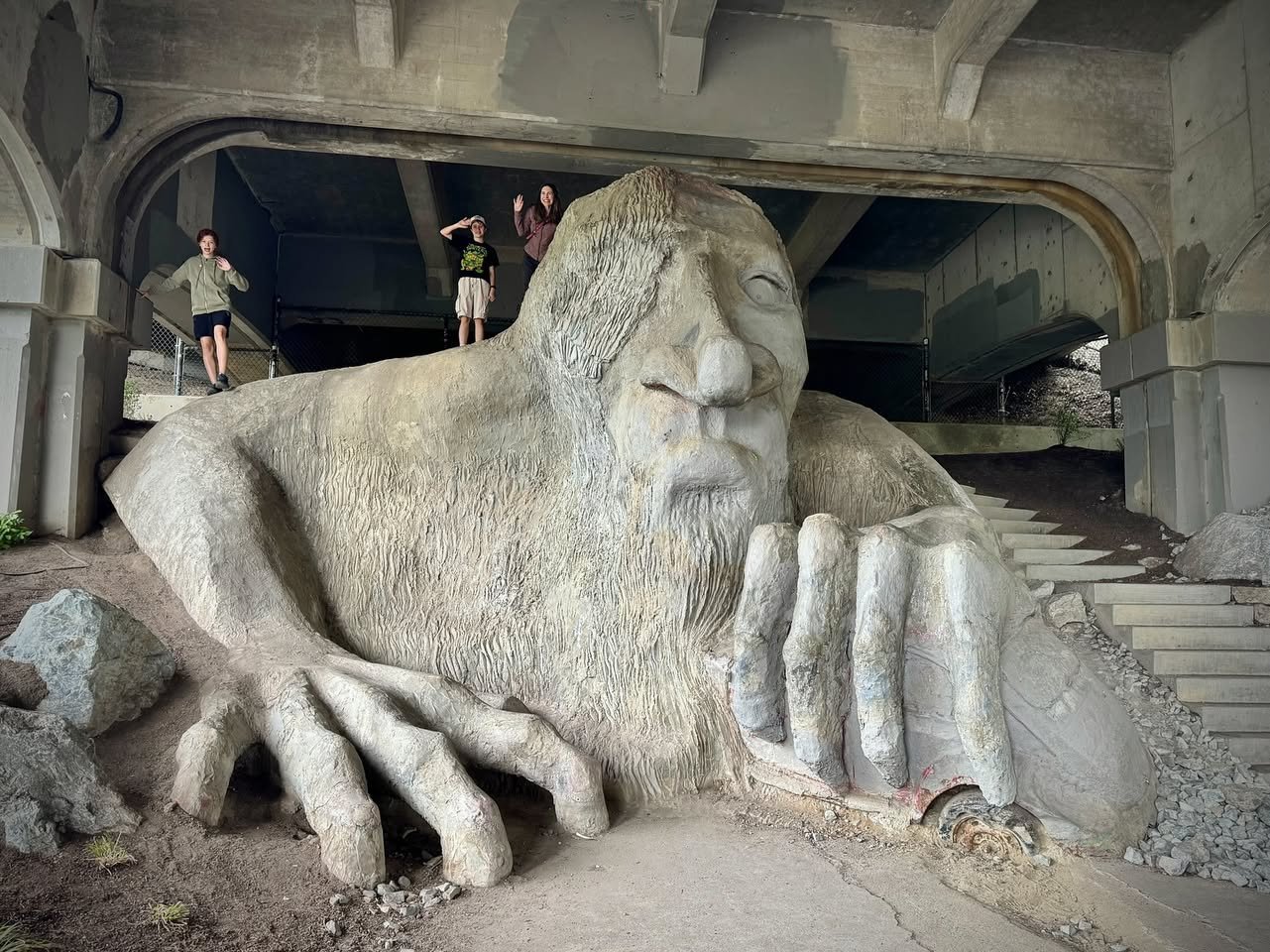 Fremont Fair A detailed grand concrete sculpture of a bearded man emerges from the earth beneath stone archways.
