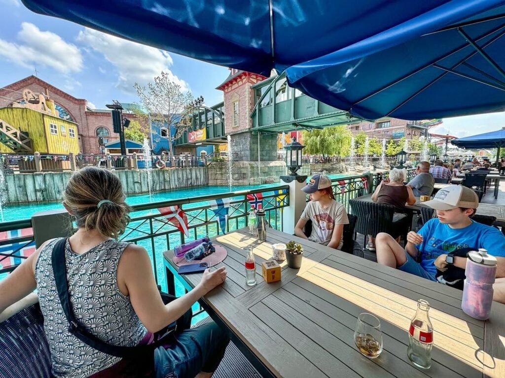 A view from an outdoor restaurant patio looking out towards the colorful Dollywood splash pad and ride structures.