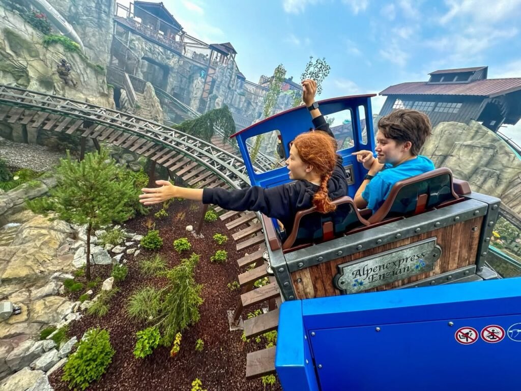 A visitor enjoys the Whillmore Express coaster at a magical theme park attraction.