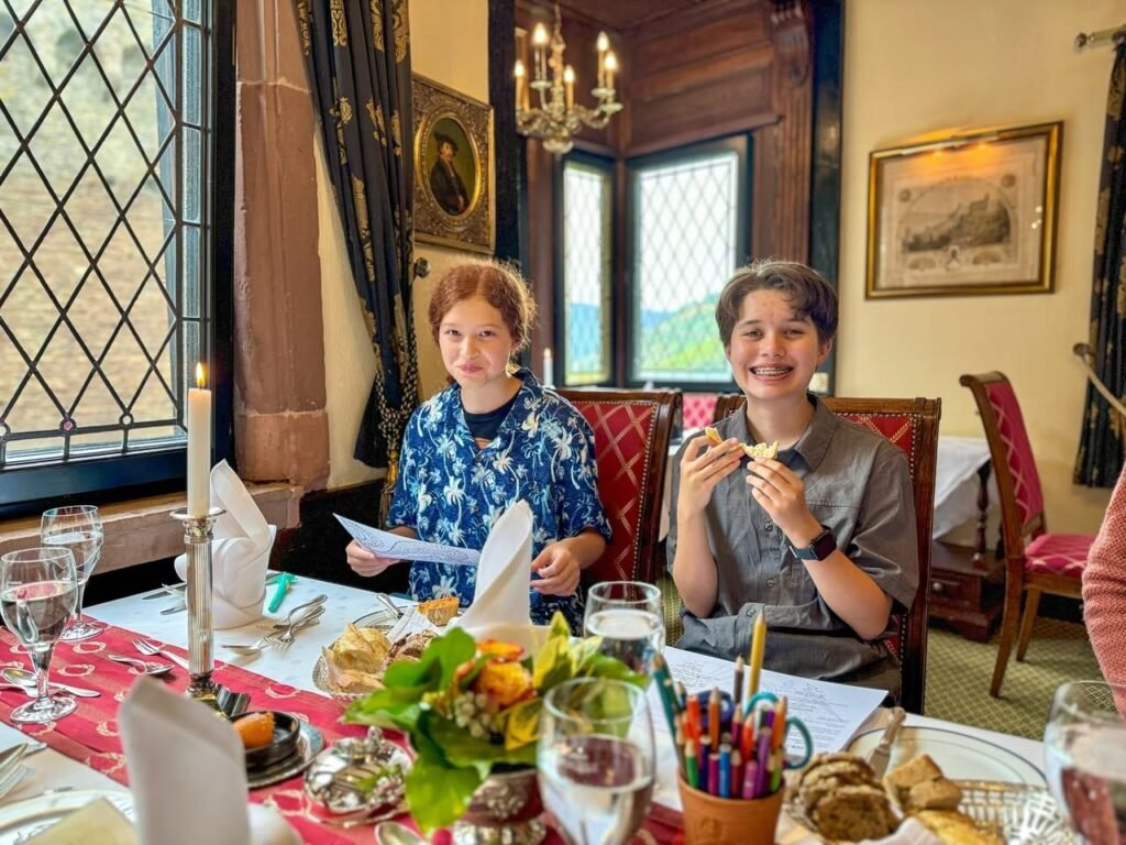 A guest enjoys a meal at a beautifully set dining table in a charming inn.