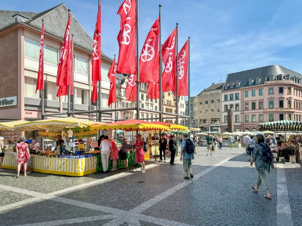 Lively Market Square with Colorful Stalls and Flags