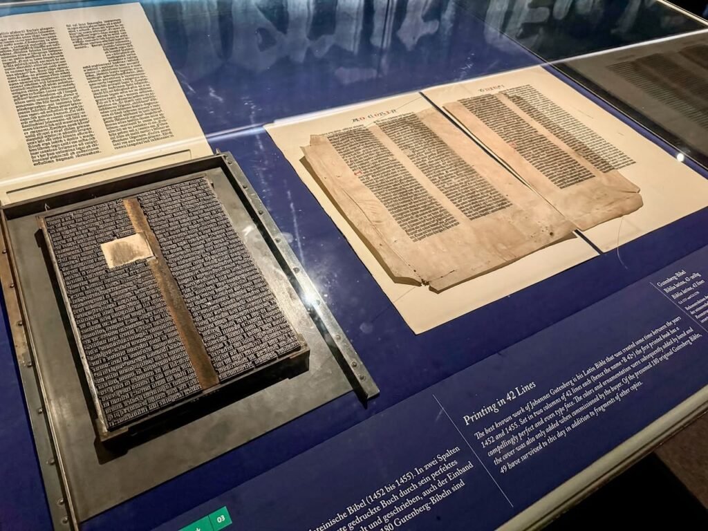 Ancient books and documents showcased in a museum exhibit. A close-up view of historical written materials.