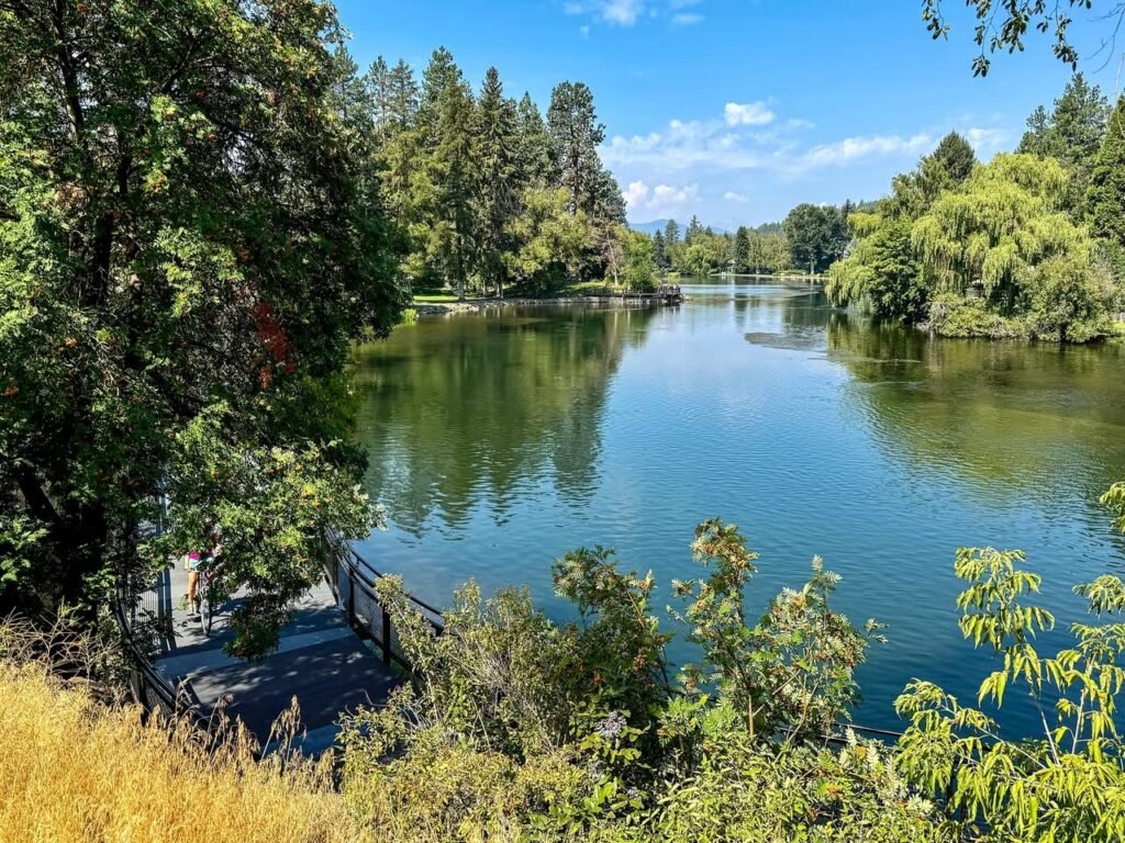 A collage of scenic photos showing a calm lake surrounded by evergreen trees and lush foliage under a clear blue sky.