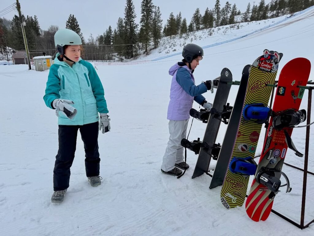 Young snowboarders at a snowy mountain resort