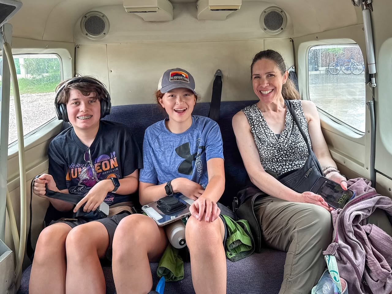 A happy family enjoys a train ride together, seated comfortably in the passenger car, looking forward to their next adventure.