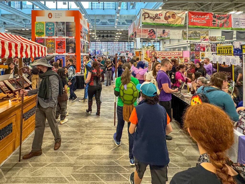 A busy indoor market with colorful vendor booths and a diverse crowd walking through the aisles under modern glass ceilings.