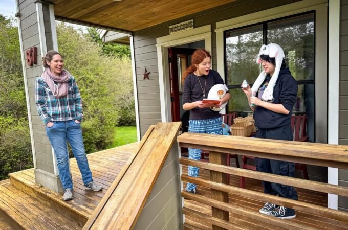 People are enjoying their time on a wooden deck, sharing a moment together.