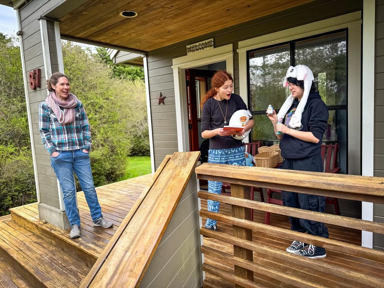 People are enjoying their time on a wooden deck, sharing a moment together.