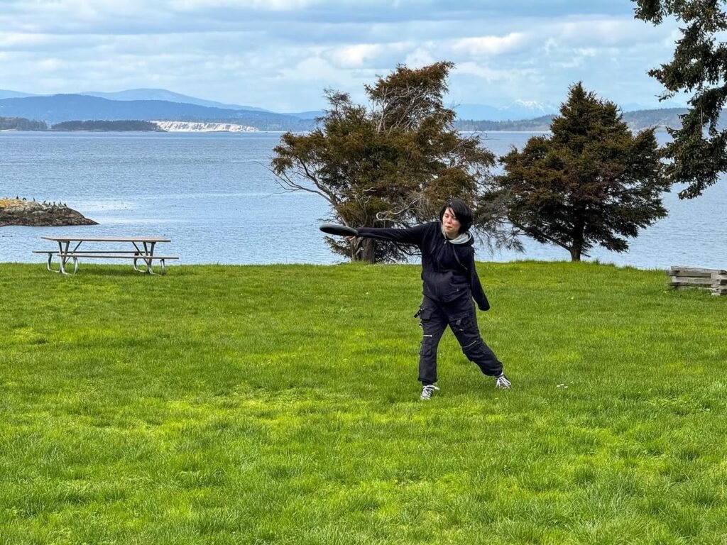 A collage of images showing a person playing on a green field with the ocean in the background.