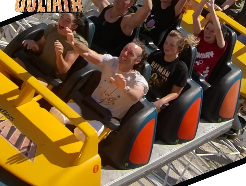 Passengers enjoy a thrilling ride on the Colossus roller coaster at Six Flags