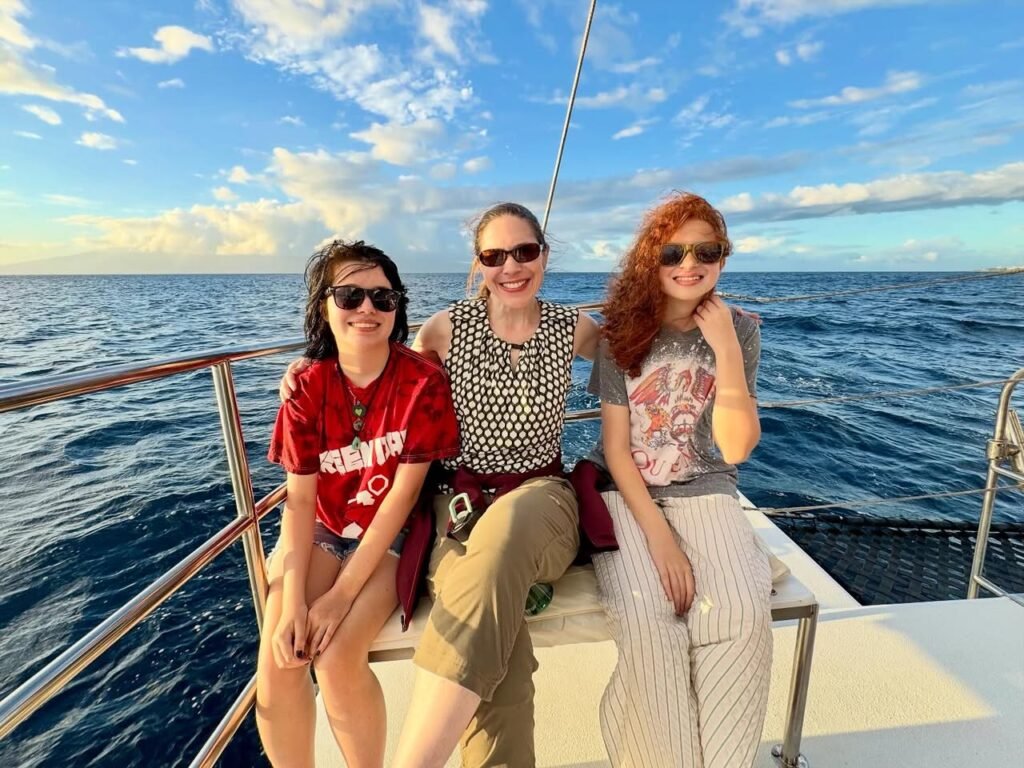 Three friends enjoy a sunny cruise on the open ocean.