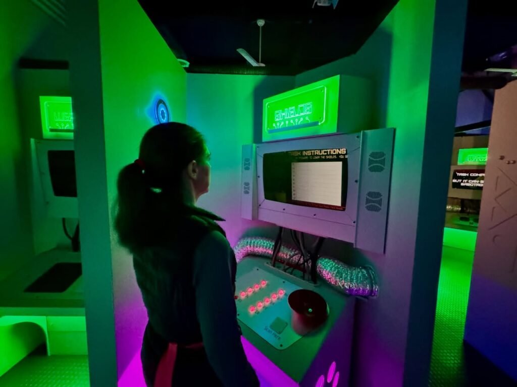An interactive science exhibit featuring illuminated control panels
