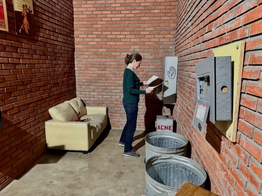 A visitor explores a mix of urban art elements in industrial brick wall space