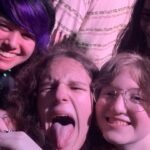 Emerald City Comic Con A group of young fans makes playful faces at a concert, with one sticking out their tongue.