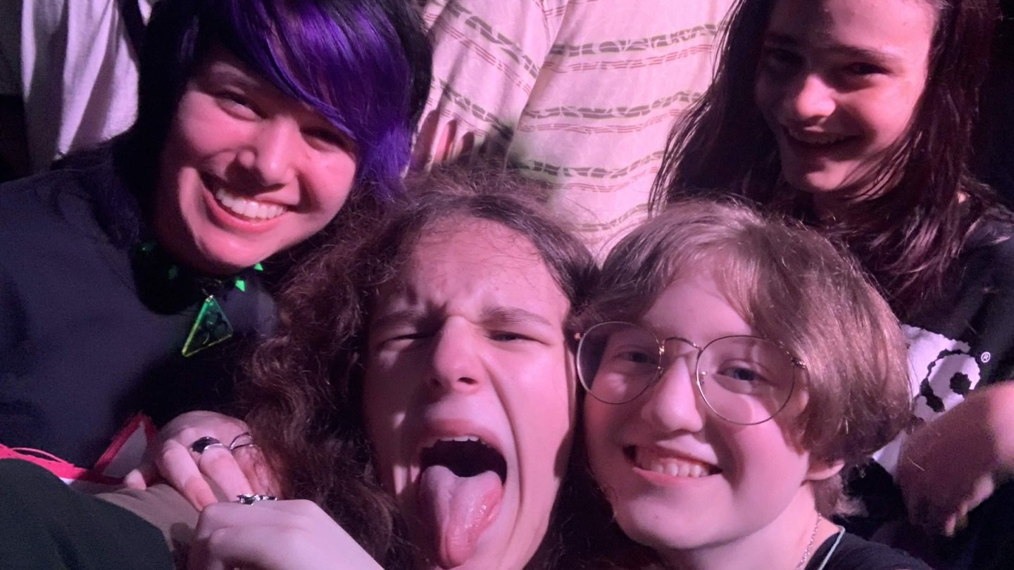 femtanyl at Neumos A group of young fans makes playful faces at a concert, with one sticking out their tongue.