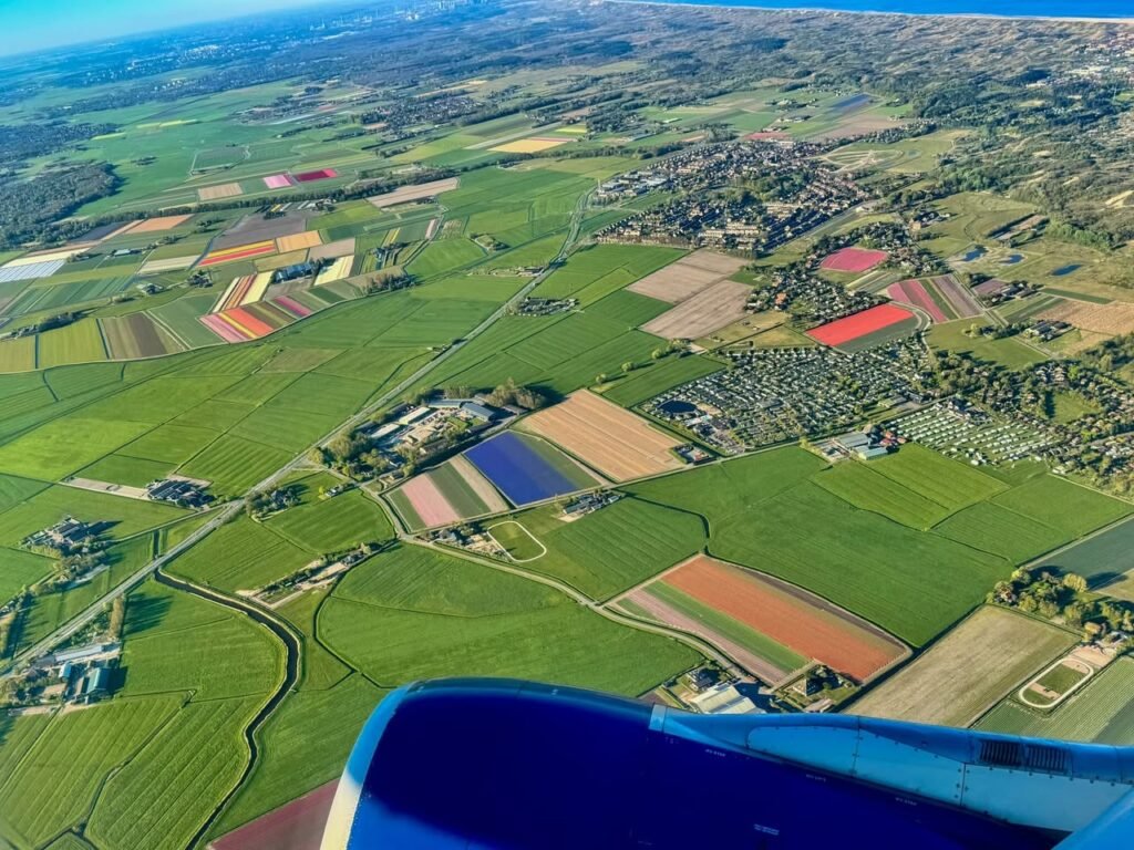 Scenic aerial view of colorful agricultural fields and farmland from a plane.
