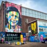 Colorful mural on the exterior of STRAAT Museum in Toronto. Street art and graffiti adorn the building's facade.