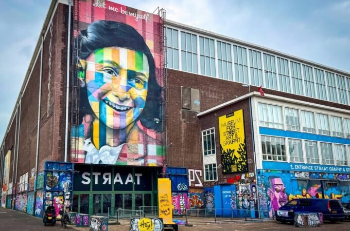 Colorful mural on the exterior of STRAAT Museum in Toronto. Street art and graffiti adorn the building's facade.