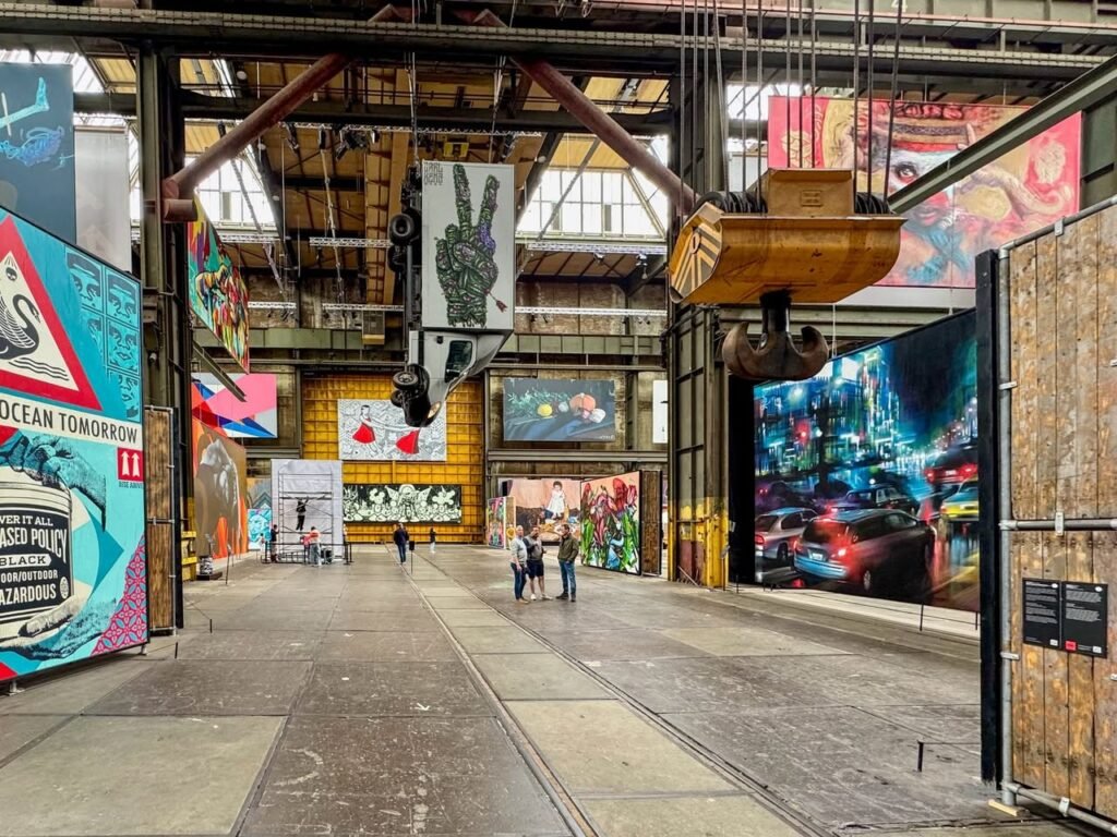 A wide view of the Tate Modern Turbine Hall featuring large-scale art installations and industrial architecture.