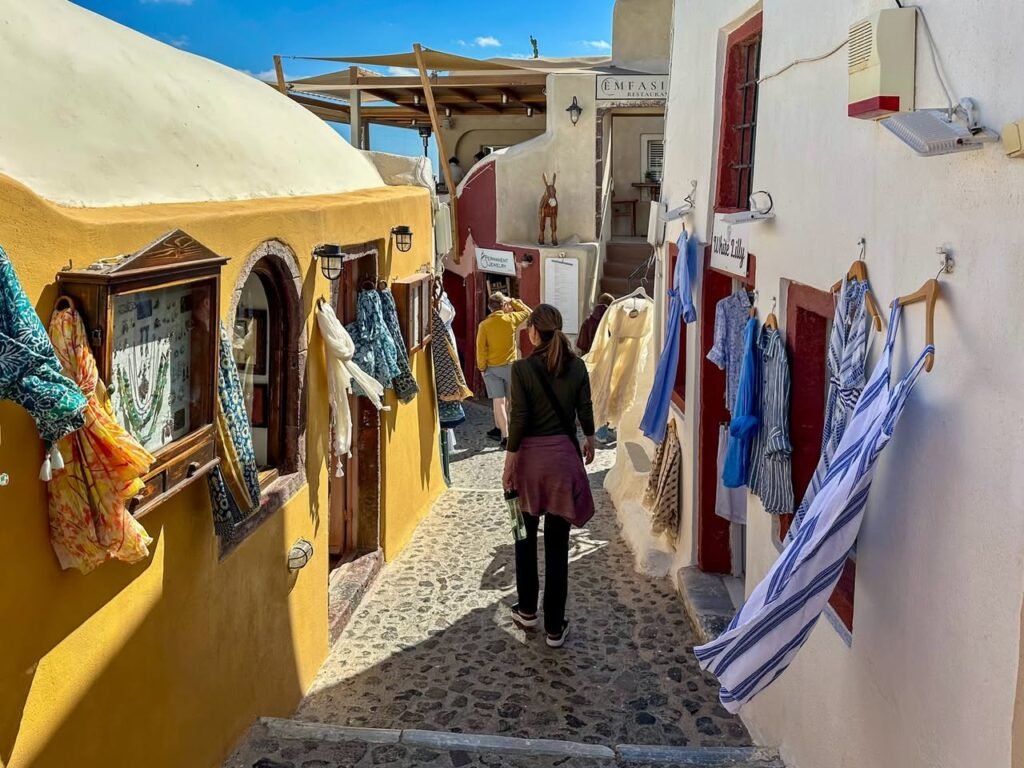 A person walking through the vibrant, narrow streets of Xideri, Rethymno, Crete.