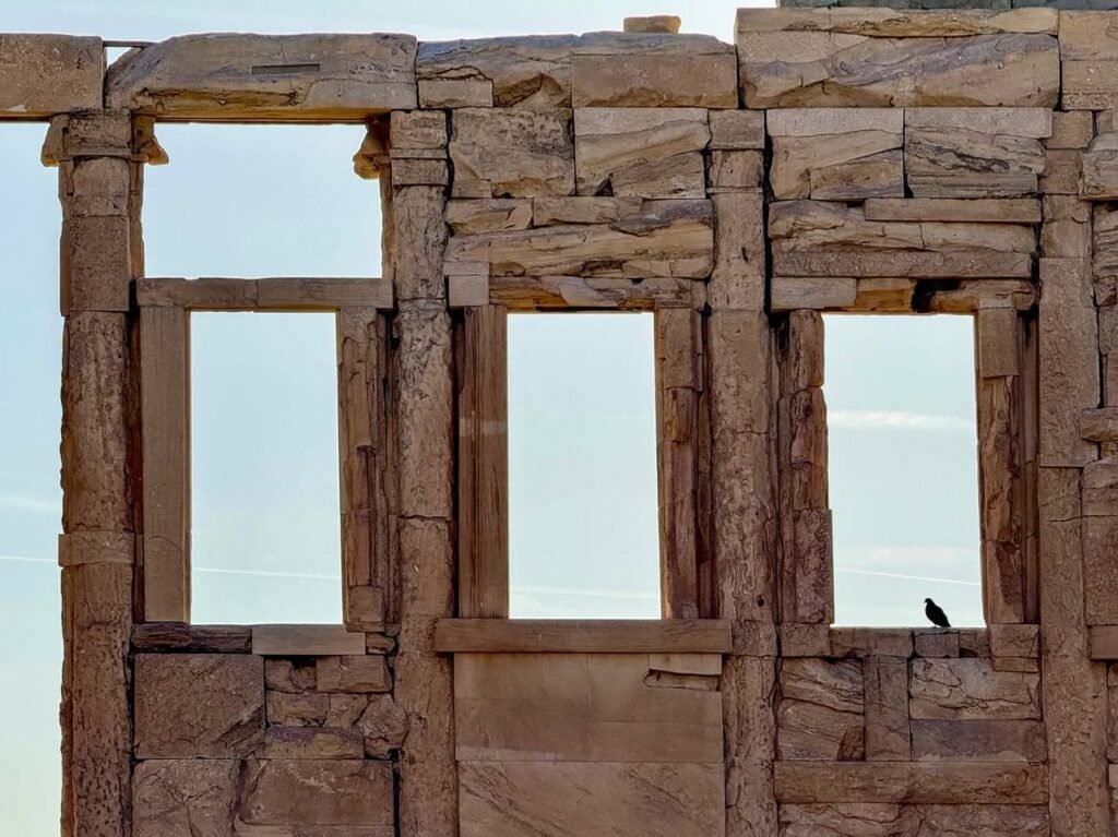 A paneled view of an ancient stone temple structure with columns and window openings against a clear sky.