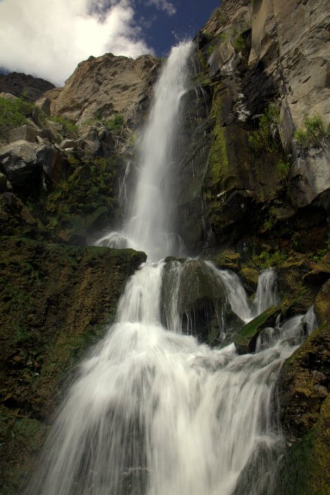 A dramatic waterfall cascading over mossy cliffs in the Pacific Northwest.