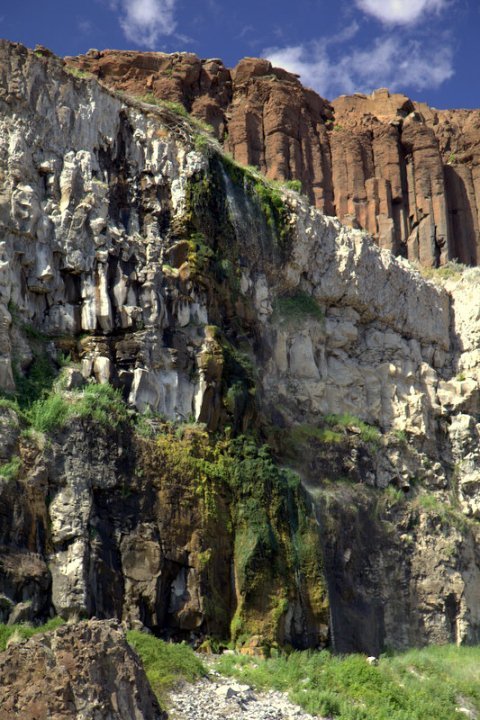 Stacked views of rugged cliffs and textured rock faces under a blue sky.