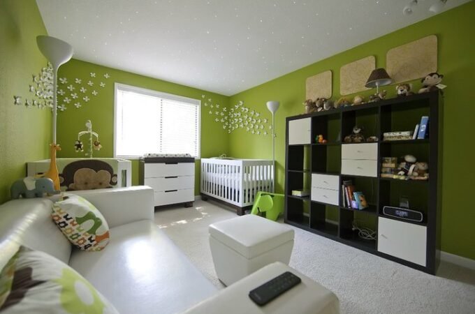 Bright children's room featuring lime green walls and a white crib.