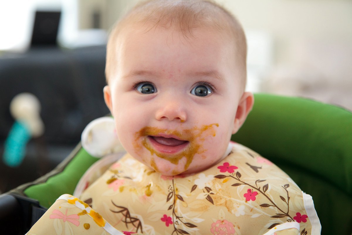 Lunch Baby enjoying family time in a high chair booster seat.