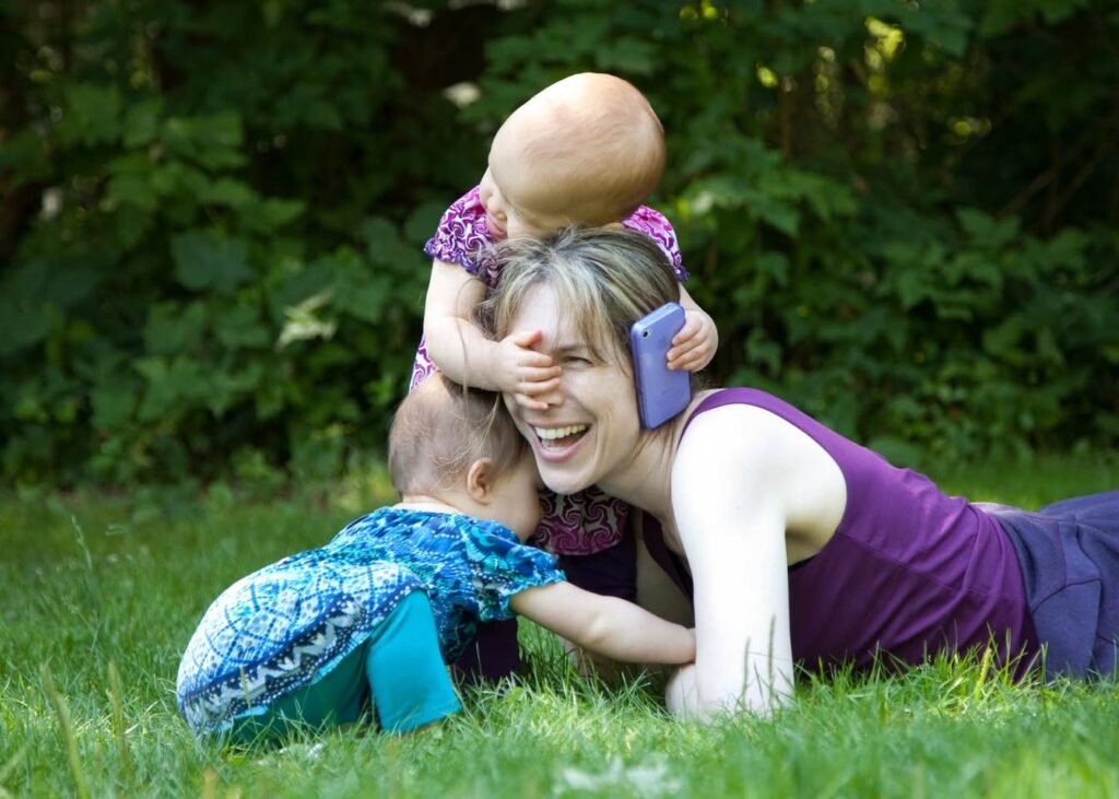 A joyful moment of mother and children playing in a lush garden.