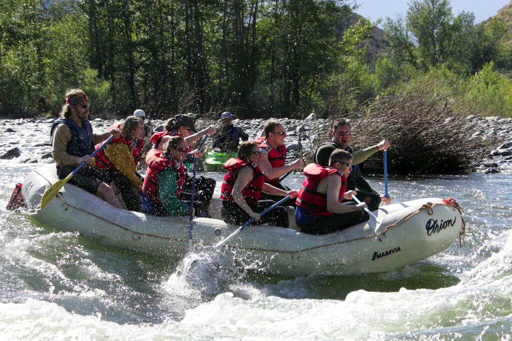 A group of friends enjoying a thrilling rafting trip through the Pacific Northwest rapids.
