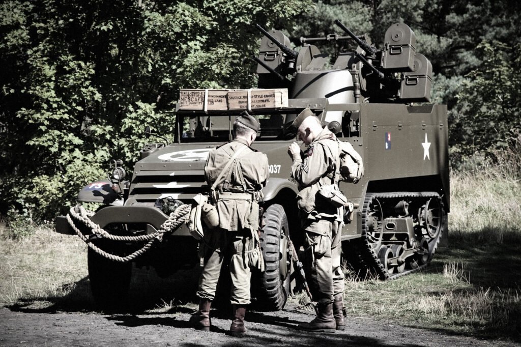 Two soldiers stand beside a vintage military vehicle surrounded by lush greenery. The scene evokes a sense of history and adventure.