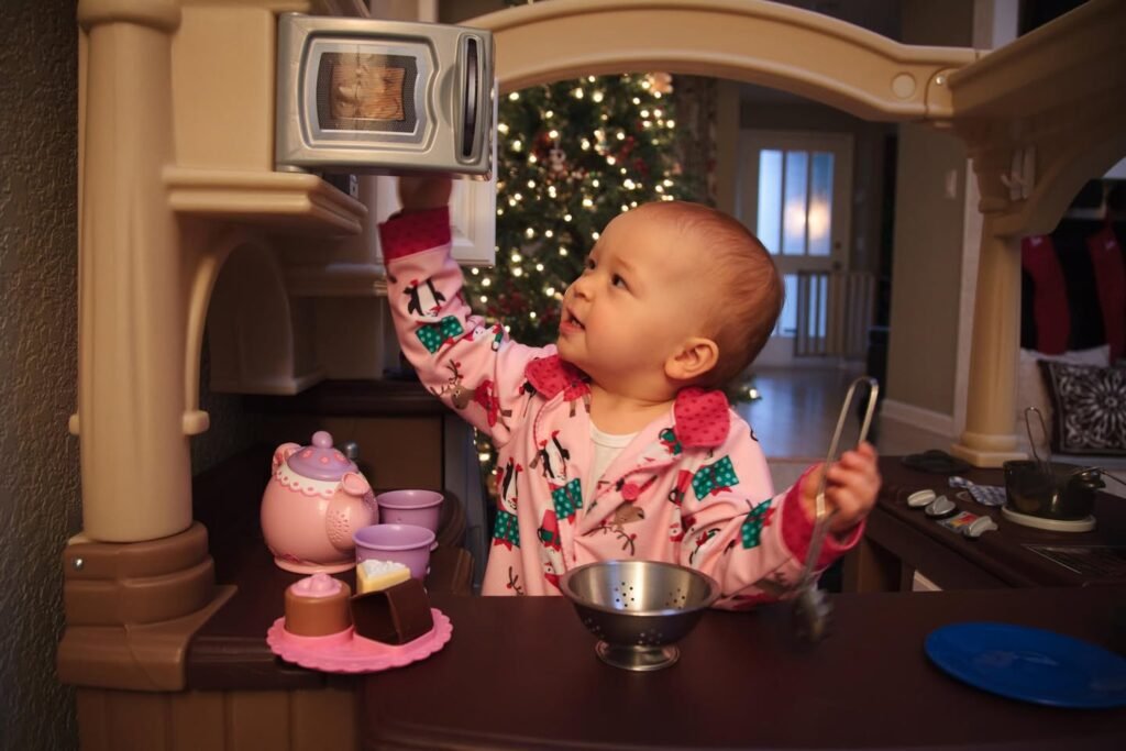 Toddler Playing With Toy Kitchen