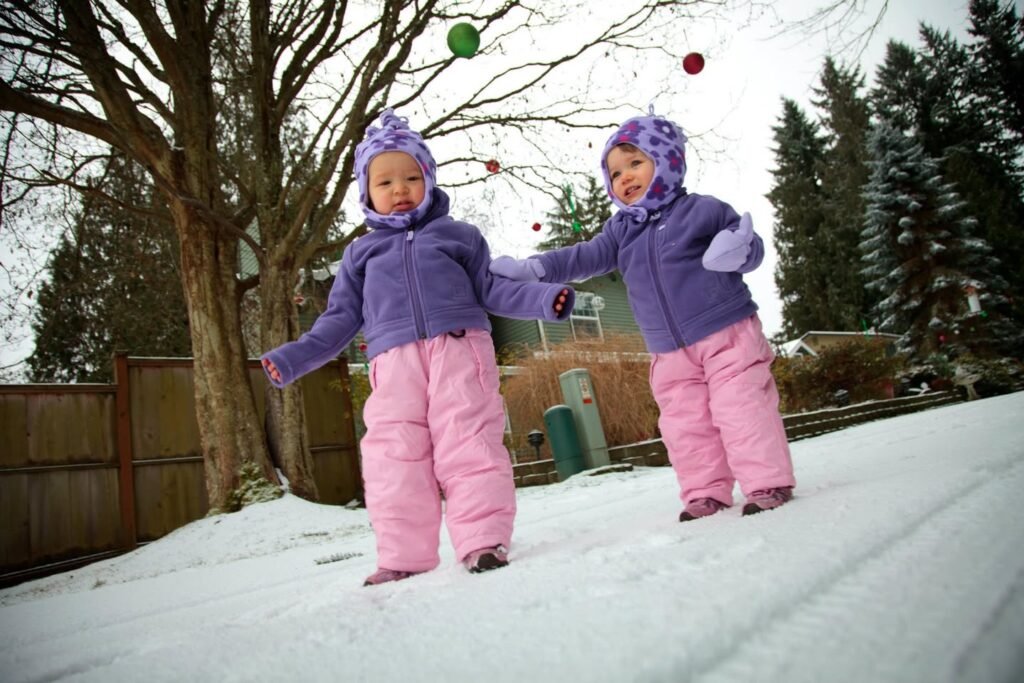 cute girl playing in first snow
