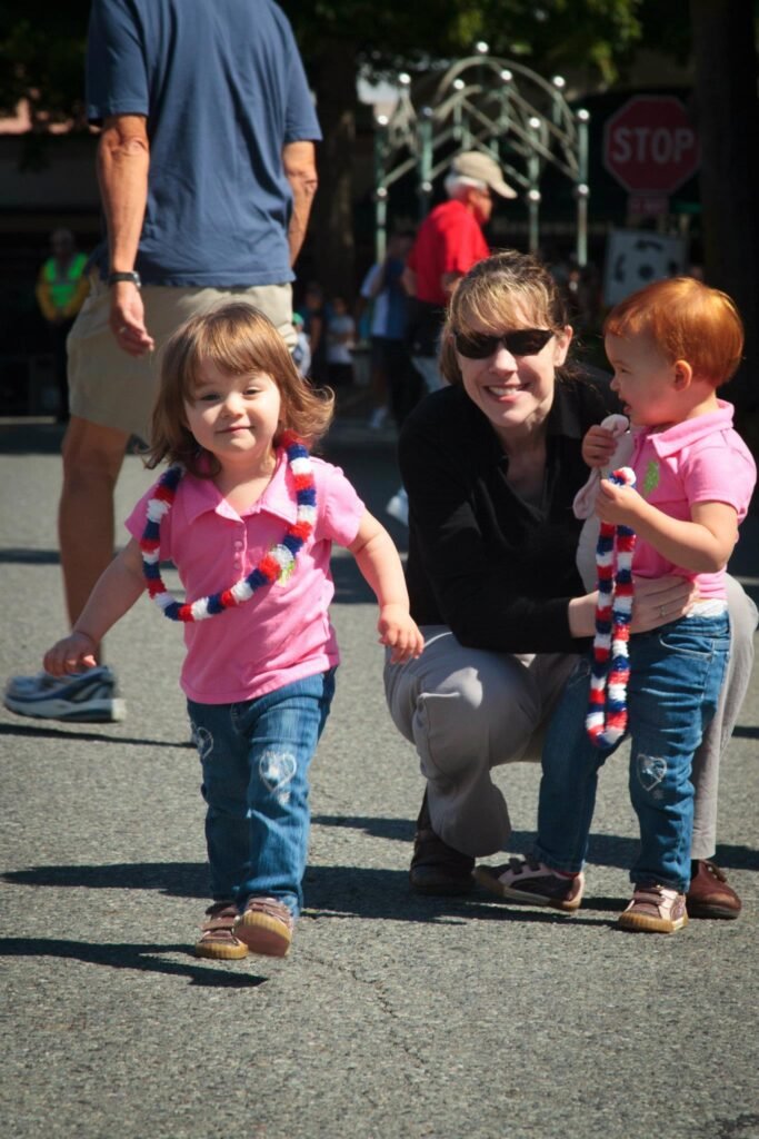 A family enjoys a day outdoors, with children wearing patriotic accessories.