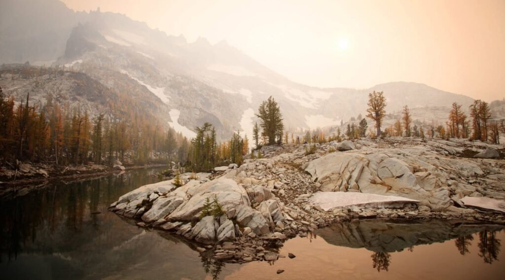 A serene river flows through a rocky landscape with a mountain backdrop in the Pacific Northwest.