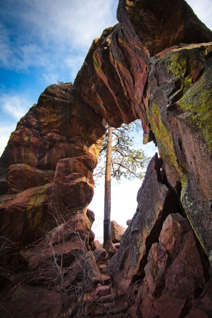 Three-panel collage of a climber ascending rugged, moss-covered granite rocks under a blue sky.