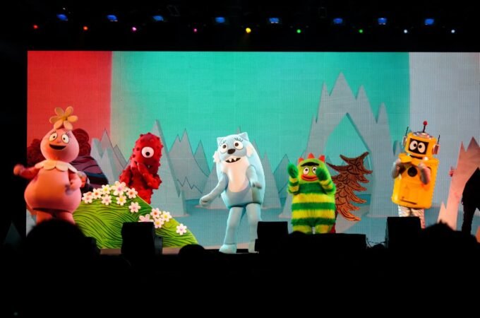 Colorful puppets from the Polar Express appear on a stage with a snowy backdrop in Portland, Oregon.