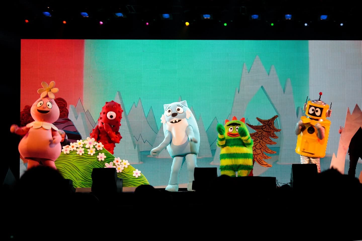 Colorful puppets from the Polar Express appear on a stage with a snowy backdrop in Portland, Oregon.