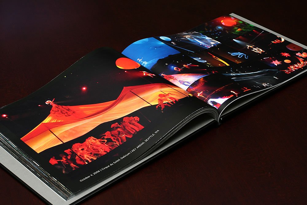 An open photo book displaying vibrant travel memories from John and Kristie's adventures.