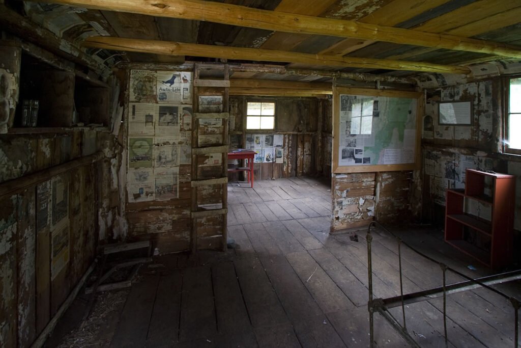 A dusty, forgotten room with worn walls and historical displays, evoking a sense of exploration.