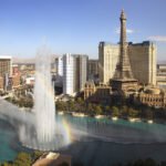 Cirque du Soleil: KA The iconic Bellagio hotel with the Eiffel Tower replica, surrounded by the famous dancing fountains creating a rainbow.