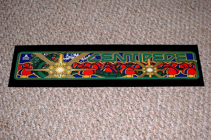 Close-up of a stained glass window labeled 'Cenotaph' with intricate designs, set against a textured carpet.